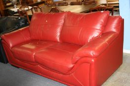 Red leather two seater sofa