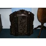 A carved hardwood fire screen and one other