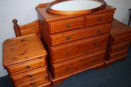 A Ducal pine chest of drawers, headboard, pair of bedside chests and mirror