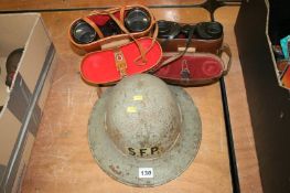 A World War II 'S.F.P.' tin helmet and two binoculars in leather cases