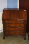 A good quality reproduction mahogany bureau with fitted interior