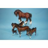 A Royal Doulton 'Shire' horse and four Beswick horses