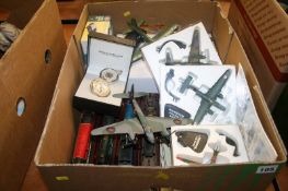 A box of model military aircraft, cars and trains etc.