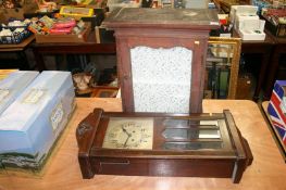 A wooden cased wall clock and cabinet