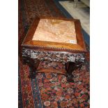 A carved Oriental hardwood plant stand with inlaid marble top, 46cm tall