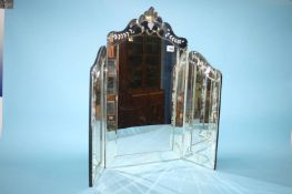 A standing bevelled edged glass mirror