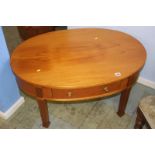 A modern mahogany single drawer oval occasional table