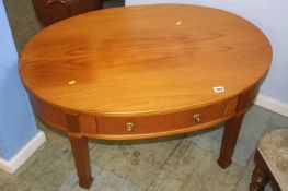 A modern mahogany single drawer oval occasional table