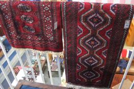 An Afghan runner with geometric central medallions in red and ivory, 55cm x 174cm and a Pakistani