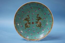 A Chinese Famille Rose charger, decorated with dragons. 34cm diameter