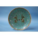 A Chinese Famille Rose charger, decorated with dragons. 34cm diameter