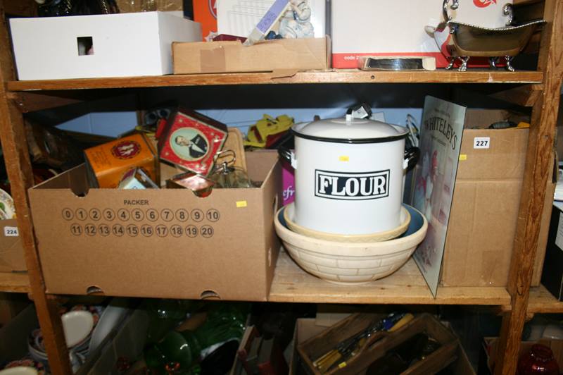 A shelf of miscellaneous, decorative tins etc.