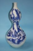 A large blue and white double gourd vase. 50cm tall