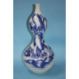 A large blue and white double gourd vase. 50cm tall