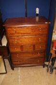 A Stag bedroom suite comprising triple door wardrobe, bedside table, dressing table, chest of five