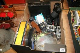 A box of cameras and lenses etc.