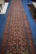 A 1930’s Hamadan Persian runner, the midnight blue ground strewn with geometric floral medallions in