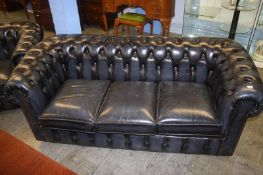 A blue leather three seater Chesterfield sofa and club chair