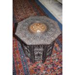 A heavily carved Middle Eastern occasional table