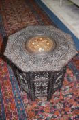 A heavily carved Middle Eastern occasional table