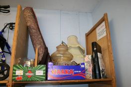 A shelf of miscellaneous, lampshades, rug etc.