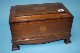 A mahogany box with rising lid, opening to reveal a secret drawer, decorated with marquetry and