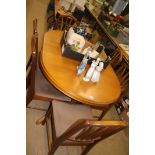 Teak extending dining table and set of six chairs