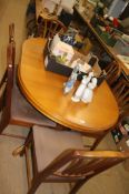 Teak extending dining table and set of six chairs