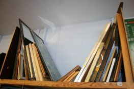 A shelf of framed pictures and prints