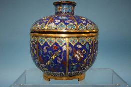 A cloisonné pot and cover decorated with Buddhist emblems. 13cm tall