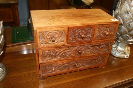 A carved wooden jewellery box