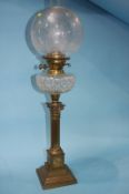 A Victorian oil lamp with etched clear glass shade and facet cut reservoir. 74cm height