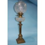 A Victorian oil lamp with etched clear glass shade and facet cut reservoir. 74cm height