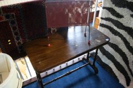 A mahogany rectangular table and a 1960s magazine rack