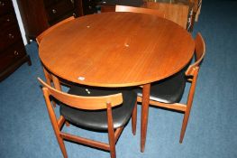 A set of four G Plan chairs by IB Kofod Larsen and a teak circular table