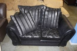 Black two seater settee and a brown recliner