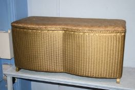 A gold Lloyd Loom ottoman, a basket weave ottoman and a linen box