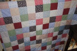 A hand stitched patchwork quilt