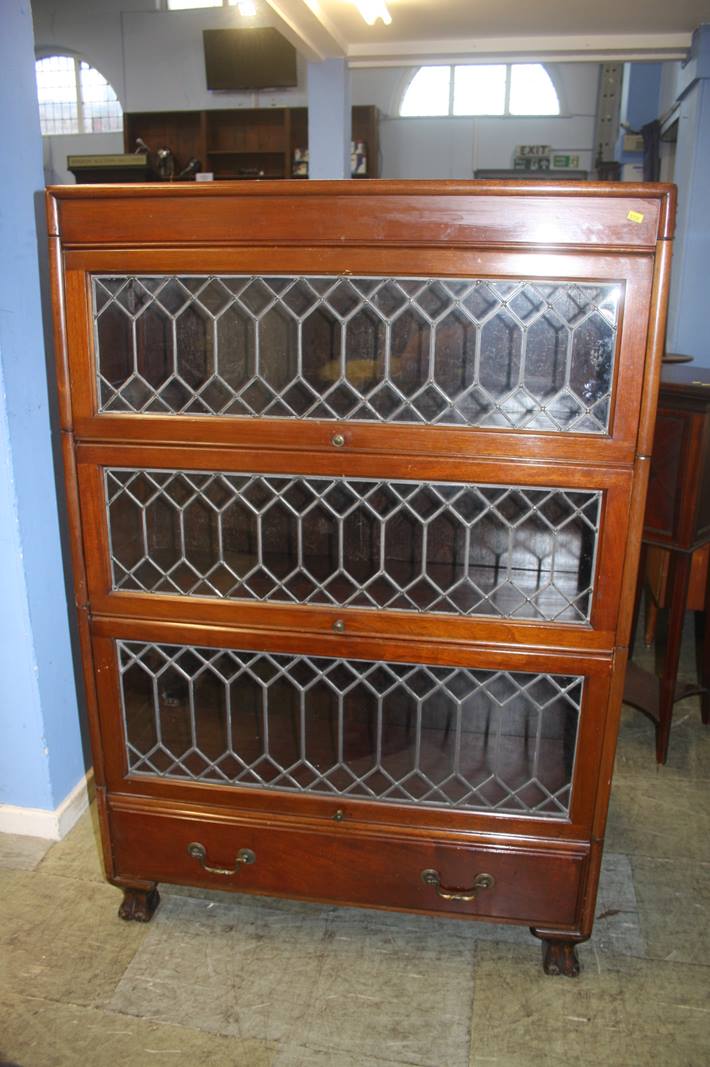 A mahogany three tier stacking bookcase, with leaded glass doors