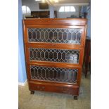 A mahogany three tier stacking bookcase, with leaded glass doors