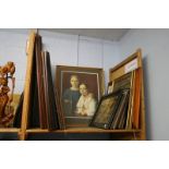 Shelf of framed pictures and prints