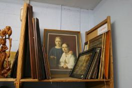 Shelf of framed pictures and prints