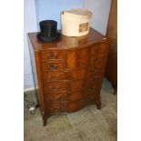 A reproduction mahogany serpentine fronted chest of drawers