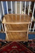 An Ercol Golden Dawn three tier tea trolley