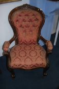 A Victorian button back armchair