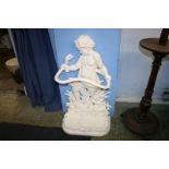 A large stick stand with cherub and entwined snake decoration