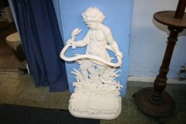 A large stick stand with cherub and entwined snake decoration