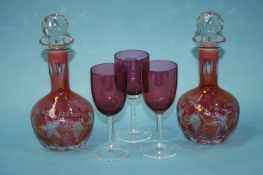 Two cranberry coloured decanters and six glasses