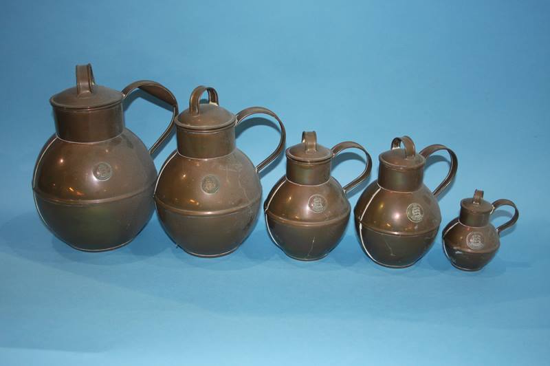 A set of five copper Guernsey measures and two tankards