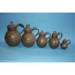A set of five copper Guernsey measures and two tankards